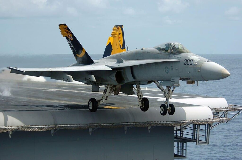 Fighter jet slips off the hangar deck of a US aircraft carrier in the Red Sea, one minor injury