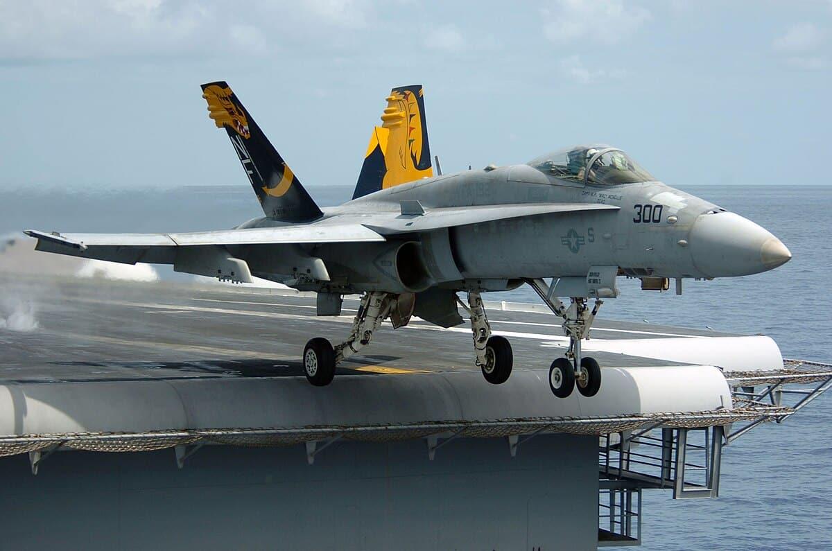 Fighter jet slips off the hangar deck of a US aircraft carrier in the Red Sea, one minor injury