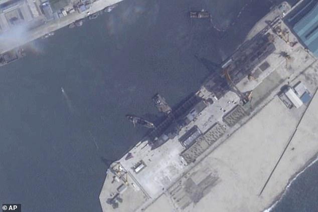 North Korea pulls capsized warship upright after botched launch, report says