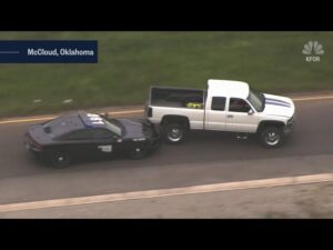 Wild police chase as man in back of pick-up hurls wooden boards at cops before multi-car crash driving wrong way down highway